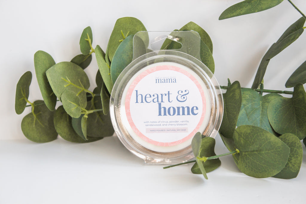 Heart and home wax melt with a greenery background. 