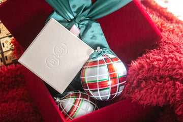 Red and green holiday giftbox with ornaments and The Always Busy Mama jewelry box.